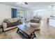 Open concept living room featuring a ceiling fan, sliding glass doors, and views of the backyard at 13434 W Rovey Ave, Litchfield Park, AZ 85340