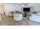 Bright living room with a ceiling fan and entertainment center at 13434 W Rovey Ave, Litchfield Park, AZ 85340