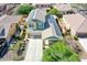 Stunning aerial view of a property with solar panels, a lush green lawn, and mature landscaping at 14897 W Valentine St, Surprise, AZ 85379
