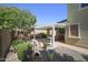 Large landscaped back yard with a covered patio and a built-in grill at 14897 W Valentine St, Surprise, AZ 85379