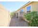 Low-maintenance backyard with gravel, mature landscaping, and storage units near the house at 14897 W Valentine St, Surprise, AZ 85379