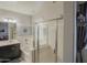 Bathroom featuring a tub, glass-enclosed shower, a dark vanity, and a light and dark gray wall color at 14897 W Valentine St, Surprise, AZ 85379