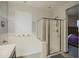 Bathroom featuring separate tub and shower with neutral tile work, paint, and an exterior window at 14897 W Valentine St, Surprise, AZ 85379