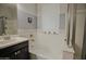 Bathroom featuring separate tub and shower with neutral tile work, paint, and an exterior window at 14897 W Valentine St, Surprise, AZ 85379