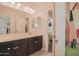 Ensuite bathroom featuring stylish vanity with double sinks, and access to the bedroom at 14897 W Valentine St, Surprise, AZ 85379