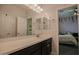 Bathroom with double sink vanity and mirror, offering seamless access to an adjacent bedroom at 14897 W Valentine St, Surprise, AZ 85379