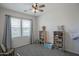 This is a bedroom with a window, and shelves at 14897 W Valentine St, Surprise, AZ 85379