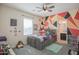 A playful bedroom design featuring painted geometric shapes and an ensuite bathroom at 14897 W Valentine St, Surprise, AZ 85379