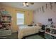 Cozy bedroom with stylish decor, a ceiling fan, and a large window for natural light at 14897 W Valentine St, Surprise, AZ 85379