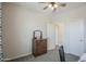 Bedroom featuring neutral paint, carpet, a ceiling fan, a window, curtains, and furniture at 14897 W Valentine St, Surprise, AZ 85379