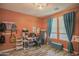 Well-lit bedroom showcasing a study area with a desk, storage and decorative wall art at 14897 W Valentine St, Surprise, AZ 85379