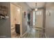 Hallway and powder room near the front entrance with laminate flooring at 14897 W Valentine St, Surprise, AZ 85379