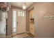 A neutral-colored entryway with stylish decor, a white front door, and modern lighting at 14897 W Valentine St, Surprise, AZ 85379