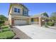 Two-story home shows a two-car garage, covered entry, and a well-kept yard at 14897 W Valentine St, Surprise, AZ 85379
