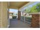 Covered front porch features brick columns and a white railing, perfect for relaxing at 14897 W Valentine St, Surprise, AZ 85379