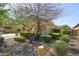 Inviting home showcasing drought resistant landscaping, and a lush front yard at 14897 W Valentine St, Surprise, AZ 85379