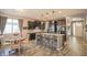 Spacious open kitchen and dining area with island, stainless appliances, and wood-look flooring at 14897 W Valentine St, Surprise, AZ 85379