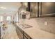 View of modern kitchen with stainless steel cooktop, granite countertops, and dark cabinets at 14897 W Valentine St, Surprise, AZ 85379