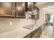 Sleek kitchen showing subway tile backsplash, granite countertops, and stainless steel cooktop at 14897 W Valentine St, Surprise, AZ 85379
