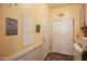 Well-lit laundry room with decorative signage, ample storage, and convenient access to laundry appliances at 14897 W Valentine St, Surprise, AZ 85379
