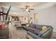 Spacious living room featuring a large sectional sofa, wood-look flooring, and an open layout to the kitchen at 14897 W Valentine St, Surprise, AZ 85379