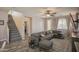 Spacious living room featuring gray sectional sofa, accent pillows, and stairway at 14897 W Valentine St, Surprise, AZ 85379