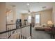 Bright living room with a cozy sitting area, ceiling fan, and access to the staircase at 14897 W Valentine St, Surprise, AZ 85379