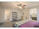 Serene main bedroom featuring carpet, a wood bedframe and access to an en-suite bathroom at 14897 W Valentine St, Surprise, AZ 85379