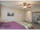 Bright and airy main bedroom with a wood bed frame, carpeted floors, and neutral walls, promoting relaxation at 14897 W Valentine St, Surprise, AZ 85379