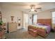 Comfortable main bedroom featuring a wood-framed bed, soft carpeting, and access to the en-suite bathroom at 14897 W Valentine St, Surprise, AZ 85379