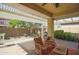 Charming covered patio with brick flooring, comfortable seating, and a built-in grill, perfect for outdoor entertaining at 14897 W Valentine St, Surprise, AZ 85379