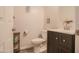 Powder room with modern vanity, brushed nickel faucet, and decorative art at 14897 W Valentine St, Surprise, AZ 85379