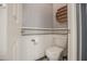 Powder room with wainscoting, decorative wall art and tiling, toilet, and neutral wall paint at 14897 W Valentine St, Surprise, AZ 85379