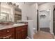 Full bathroom with granite counters, double vanity, tile floors, shower, and walk-in closet at 15225 N 100Th St # 1209, Scottsdale, AZ 85260