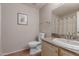 Cozy bathroom with framed mirror, picture, and a vanity with countertop space at 15225 N 100Th St # 1209, Scottsdale, AZ 85260