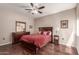 Comfortable bedroom featuring a ceiling fan, wood floors, and matching furniture set at 15225 N 100Th St # 1209, Scottsdale, AZ 85260