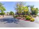 Well-maintained community entrance with lush landscaping, decorative flowers, and gated access at 15225 N 100Th St # 1209, Scottsdale, AZ 85260