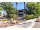 Welcoming entrance to Villages North with lush landscaping and mature palm trees at 15225 N 100Th St # 1209, Scottsdale, AZ 85260