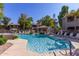 Sparkling community pool and lounge area with lush trees and shade creating a relaxing atmosphere at 15225 N 100Th St # 1209, Scottsdale, AZ 85260