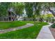 Beautiful green space with mature trees and a rock-lined drainage area at 15225 N 100Th St # 1209, Scottsdale, AZ 85260