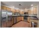 Well-lit kitchen featuring stainless steel appliances and light wood cabinetry at 15225 N 100Th St # 1209, Scottsdale, AZ 85260