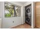 Efficient laundry area with modern washer/dryer units, storage cabinet and natural light at 15225 N 100Th St # 1209, Scottsdale, AZ 85260