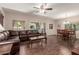 Spacious living room with hardwood floors, leather sofa, and access to outdoor patio at 15225 N 100Th St # 1209, Scottsdale, AZ 85260