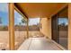 Covered back patio leading to a xeriscaped backyard with a rock bed and block wall at 16261 W Custer Ln, Surprise, AZ 85379