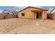 Large xeriscaped backyard featuring gravel, desert landscaping, and an inviting covered patio area at 16261 W Custer Ln, Surprise, AZ 85379