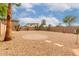 Fully enclosed xeriscaped backyard featuring gravel, a circular brick area, and desert landscaping at 16261 W Custer Ln, Surprise, AZ 85379