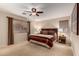 Spacious bedroom with ceiling fan, plush carpet, and neutral paint at 16261 W Custer Ln, Surprise, AZ 85379