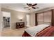 Bright bedroom boasts plush carpet, ceiling fan, and walk-in closet at 16261 W Custer Ln, Surprise, AZ 85379