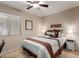 Bright bedroom features a ceiling fan, plush carpet, and neutral walls at 16261 W Custer Ln, Surprise, AZ 85379
