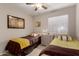 Comfortable bedroom featuring two twin beds, neutral wall color, and a nightstand between the beds at 16261 W Custer Ln, Surprise, AZ 85379